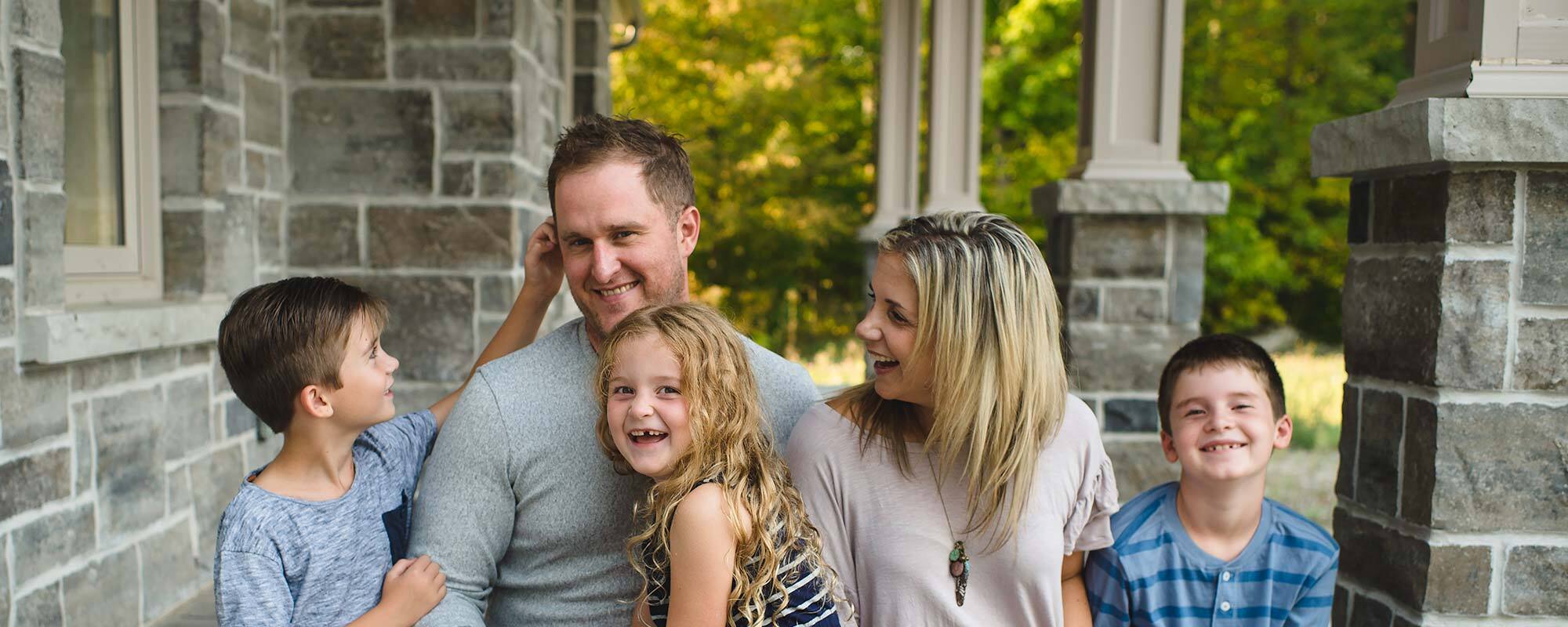 A family sitting on the porch.